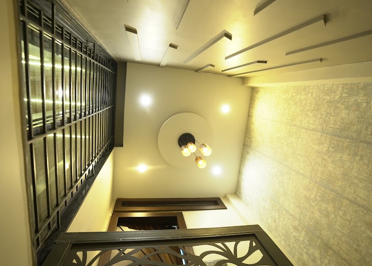 The Geometric Batten Ceiling & Amber Pendant Foyer